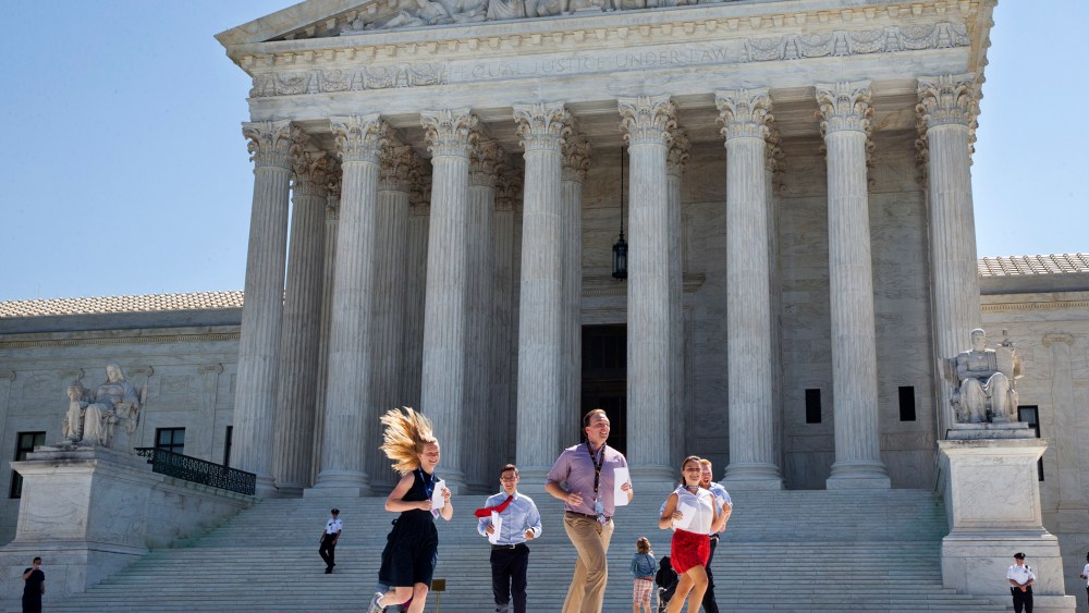 New interns run with a decision across the plaza of the Supreme Court in Washington, June 29, 2015. (Photo by Jacquelyn Martin/AP)