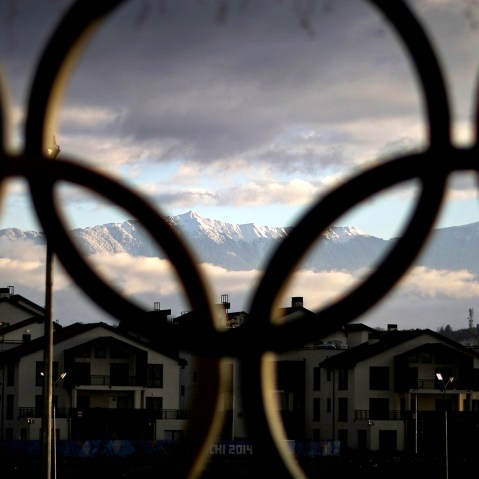 The Caucasus Mountains seen through the Olympic rings over the athlete's village in the coastal cluster, Feb. 2, 2014, in Sochi, Russia.