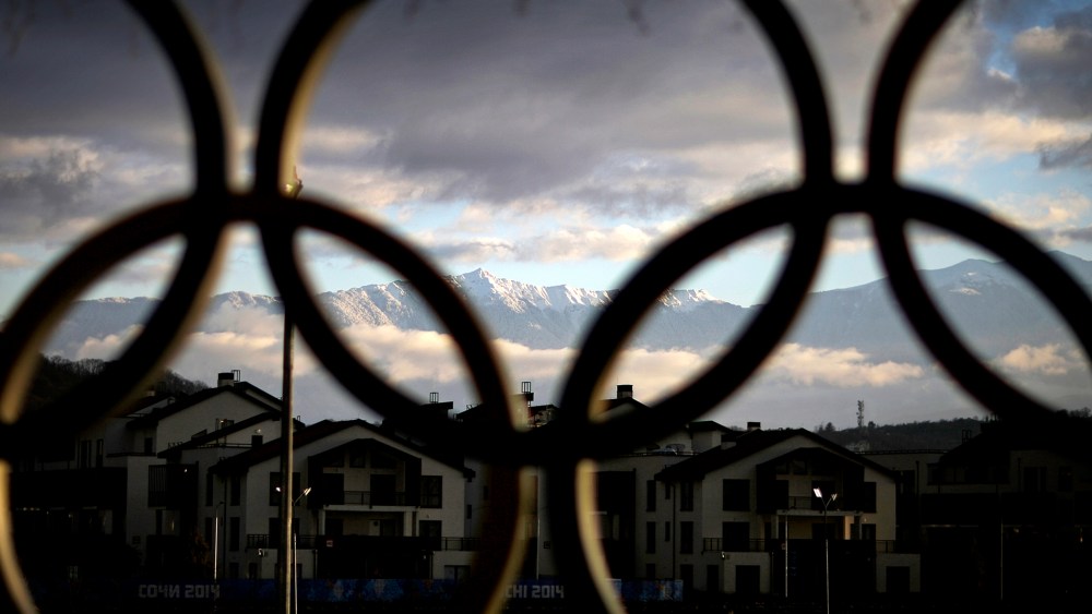 The Caucasus Mountains seen through the Olympic rings over the athlete's village in the coastal cluster, Feb. 2, 2014, in Sochi, Russia.
