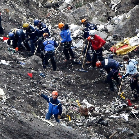 Rescue workers inspect the debris from the Germanwings jet at the crash site near Seyne-les-Alpes, France on March 26, 2015. (Photo by Laurent Cipriani/AP)
