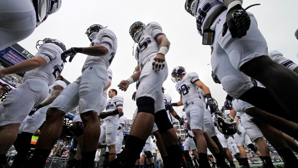 The Northwestern football team heads to the locker room after warming up before an NCAA college football game against Penn State in State College, Pa, Oct. 6, 2012.