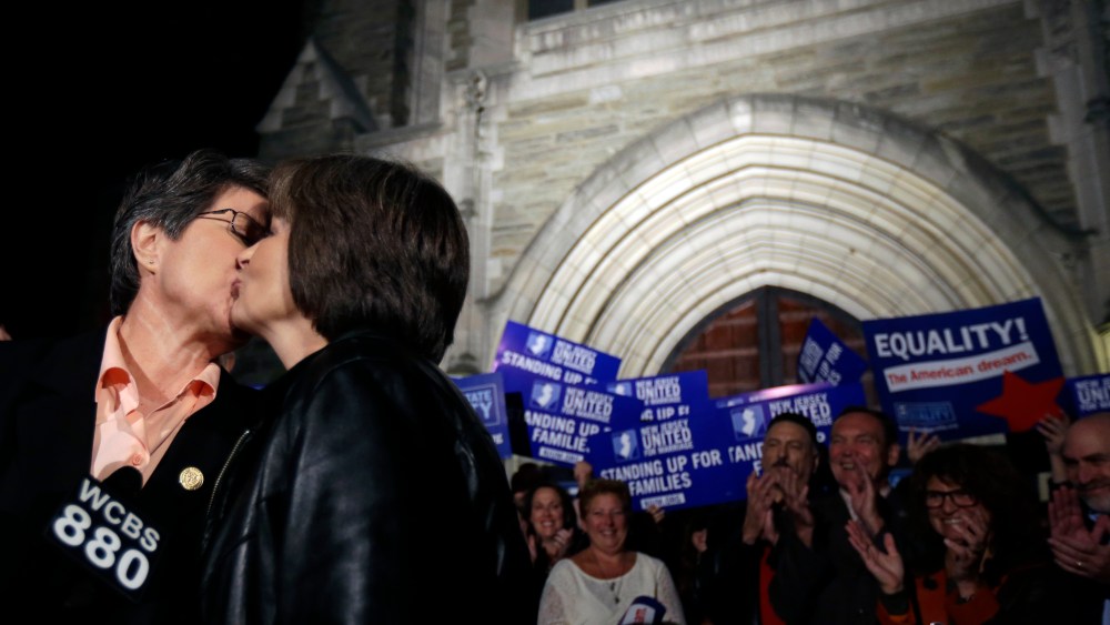 Cindy Meneghin, left, kisses her partner Maureen Kilian, both from Butler, N.J., during a news conference at Garden State Equality in Montclair, N.J.