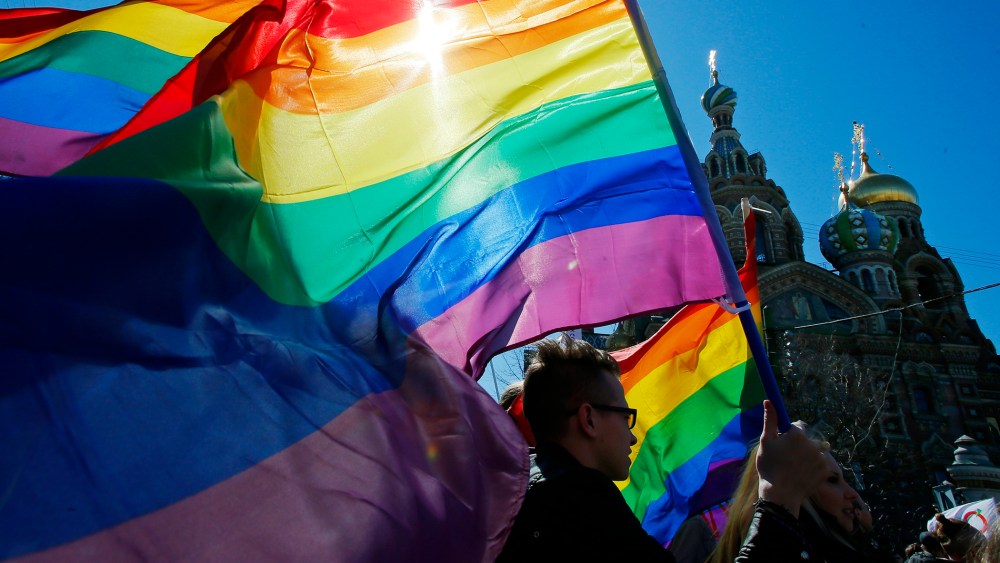 In this Wednesday, May 1, 2013, file photo, gay rights activists carry rainbow flags as they march during a May Day rally in St. Petersburg, Russia. (Photo by Dmitry Lovetsky/AP)
