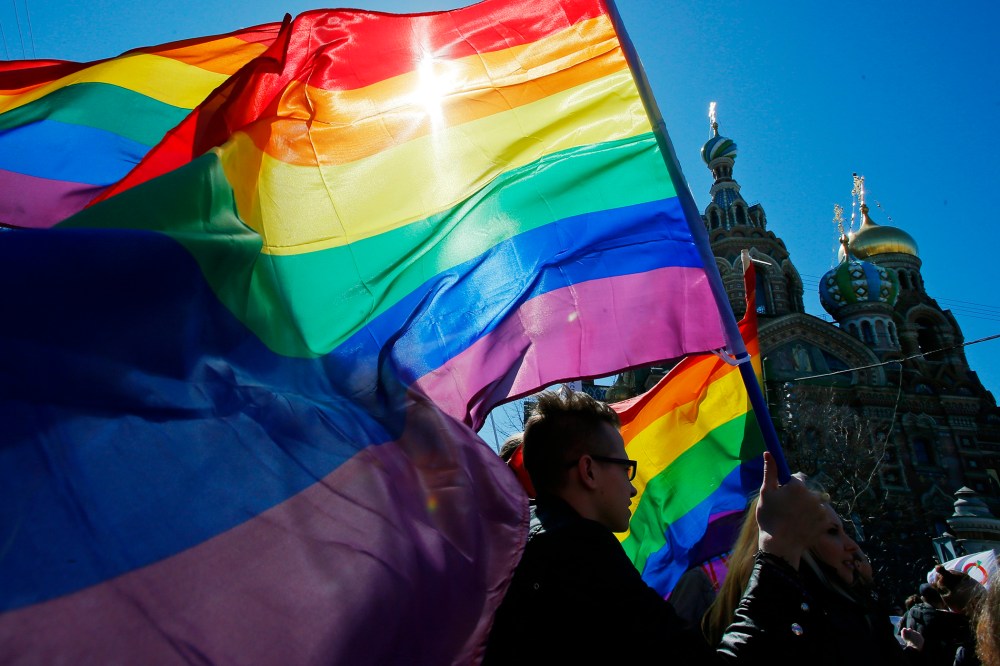 In this Wednesday, May 1, 2013, file photo, gay rights activists carry rainbow flags as they march during a May Day rally in St. Petersburg, Russia. (Photo by Dmitry Lovetsky/AP)