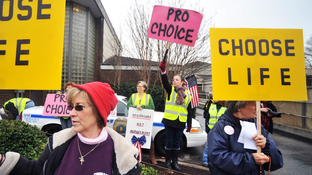 People supporting and opposing abortion demonstrate outside of the Alabama Women's Center for Reproductive Alternatives in Huntsville, Ala., Feb. 23, 2013.
