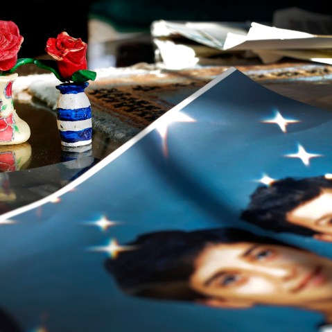 In this Dec. 10, 2014 photo, Prison artwork created by Adnan Syed sits near family photos in the home of his mother, Shamim Syed, in Baltimore, Md. (Photo by Patrick Semansky/AP)