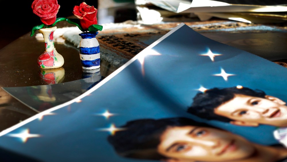 In this Dec. 10, 2014 photo, Prison artwork created by Adnan Syed sits near family photos in the home of his mother, Shamim Syed, in Baltimore, Md. (Photo by Patrick Semansky/AP)