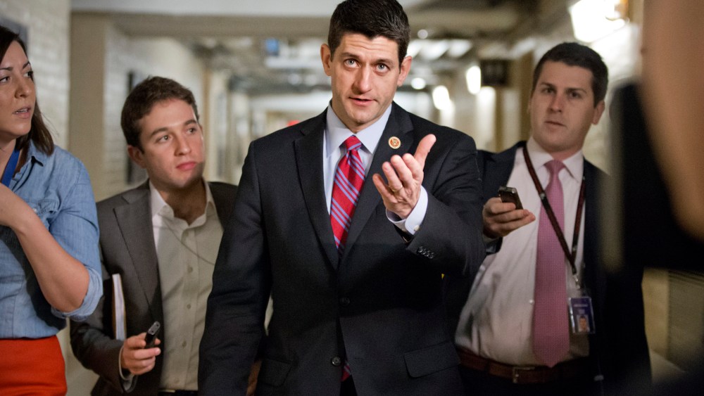 Walking through a basement corridor while talking to reporters about a budget deal Capitol Hill in Washington, Wednesday, Dec. 11, 2013.