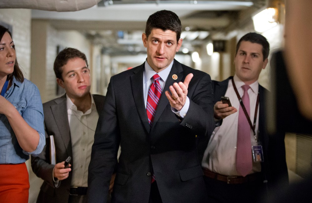 Walking through a basement corridor while talking to reporters about a budget deal Capitol Hill in Washington, Wednesday, Dec. 11, 2013.