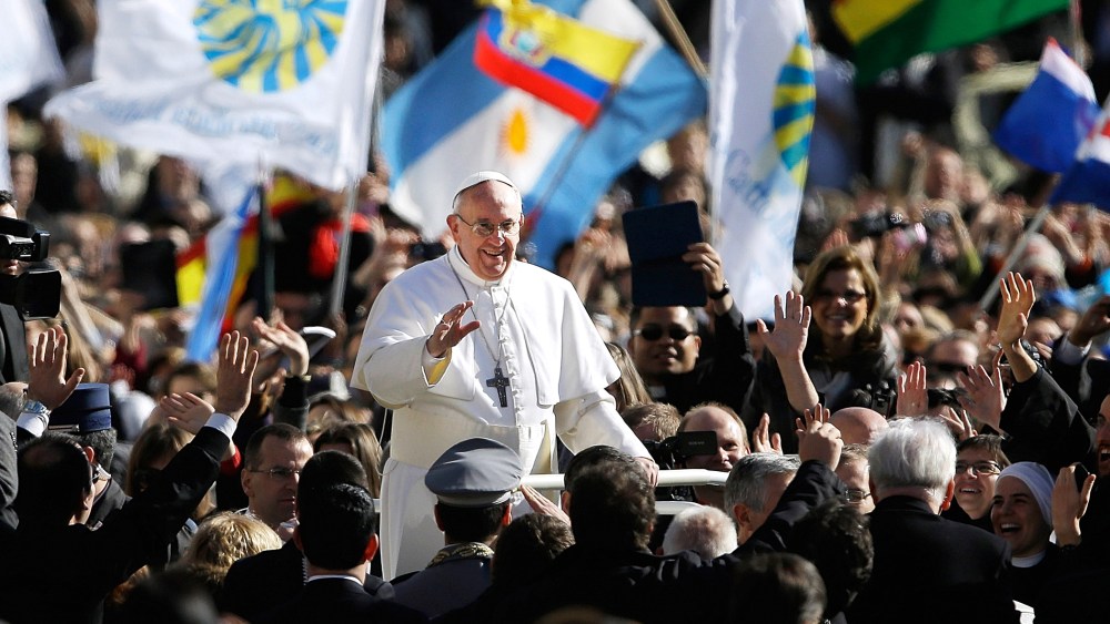Pope Francis waves to crowds as he arrives to his inauguration Mass in St. Peter's Square at the Vatican, March 19, 2013.