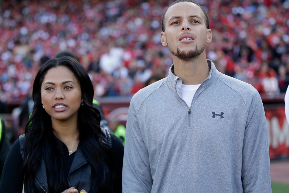Golden State Warriors player Stephen Curry and his wife Ayesha Curry watch as the San Francisco 49ers play the Carolina Panthers during the third quarter of an NFL football game in San Francisco, Nov. 10, 2013. (Photo by Marcio Jose Sanchez/AP)