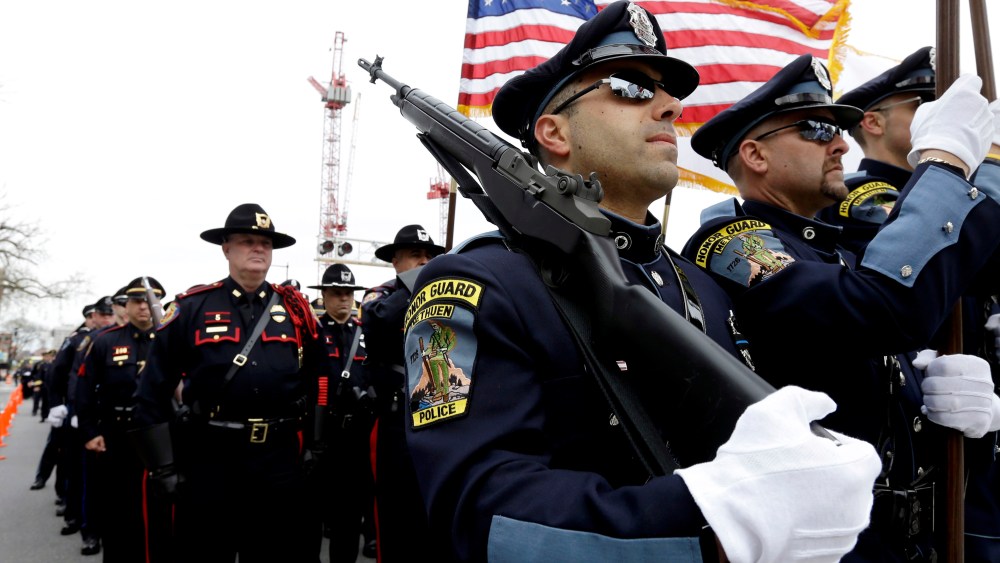 Members of a police honor guard, front, lead a column of law enforcement officials into a memorial service for fallen Massachusetts Institute of Technology police officer Sean Collier, in Cambridge, Mass., Wednesday, April 24, 2013. Collier was fatally...