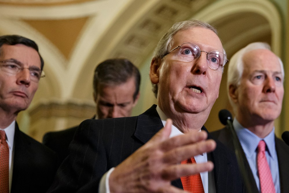 Senate Minority Leader Mitch McConnell speaks with reporters following a closed-door policy meeting at the Capitol in Washington on Dec. 2, 2014. (J. Scott Applewhite/AP)