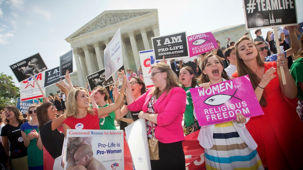 Demonstrators react to hearing the Supreme Court's decision on the Hobby Lobby case outside the Supreme Court in Washington, D.C., June 30, 2014.