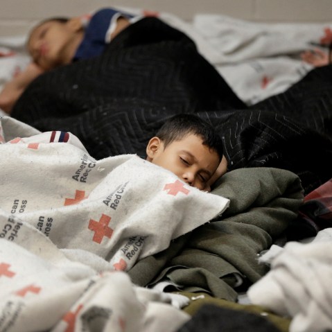 Detainees sleep in a holding cell at a U.S. Customs and Border Protection processing facility, Wednesday, June 18, 2014, in Brownsville,Texas.