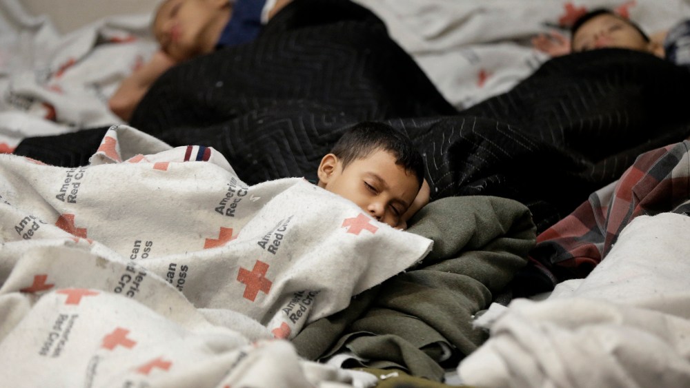 Detainees sleep in a holding cell at a U.S. Customs and Border Protection processing facility, Wednesday, June 18, 2014, in Brownsville,Texas.
