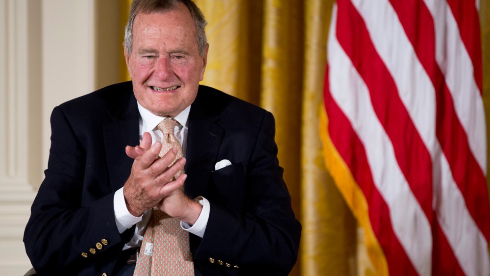 Former President George H. W. Bush applauds as he participated in a ceremony in the East Room of the White House in Washington, D.C., July 15, 2013. (Photo by Carolyn Kaster/AP)