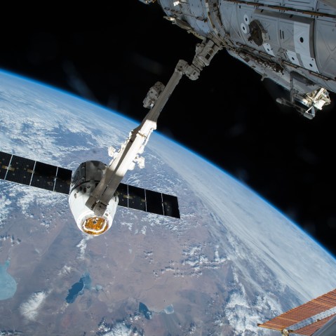 The Canadarm 2 reaches out to capture the SpaceX Dragon cargo spacecraft and prepare it to be pulled into its port on the International Space Station, April 17, 2015. (Photo courtesy of NASA/AP)