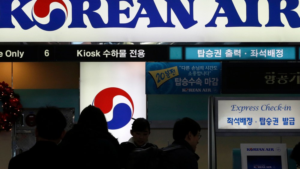 In this Dec. 16, 2014 photo, passengers wait to check in at the domestic check-in desk of Korean Air Lines Co. at Gimpo Airport in Seoul, South Korea. (Photo by Lee Jin-man/AP)