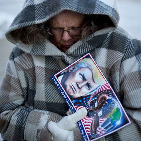 Debbie Heinick shivers while waiting in line to attend a rally for Republican presidential candidate Donald Trump, Jan. 12, 2016, in Cedar Falls, Ia. (Photo by Jae C. Hong/AP)