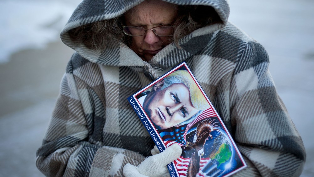 Debbie Heinick shivers while waiting in line to attend a rally for Republican presidential candidate Donald Trump, Jan. 12, 2016, in Cedar Falls, Ia. (Photo by Jae C. Hong/AP)