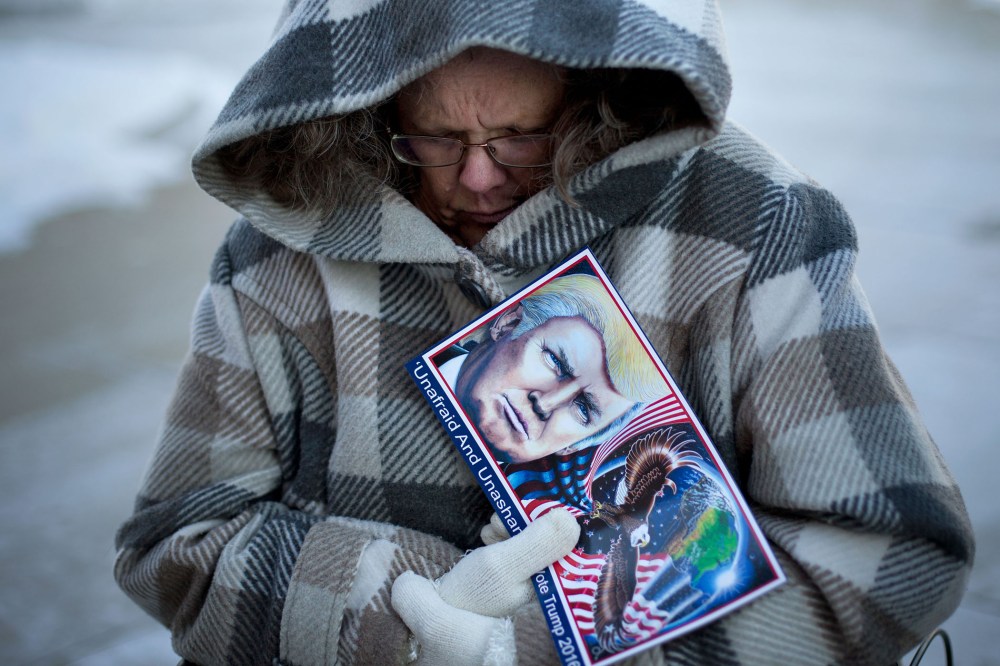 Debbie Heinick shivers while waiting in line to attend a rally for Republican presidential candidate Donald Trump, Jan. 12, 2016, in Cedar Falls, Ia. (Photo by Jae C. Hong/AP)