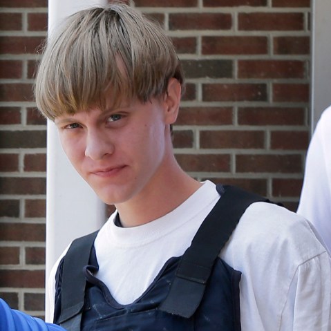 Charleston, S.C., shooting suspect Dylann Storm Roof is escorted from the Sheby Police Department in Shelby, N.C., June 18, 2015.