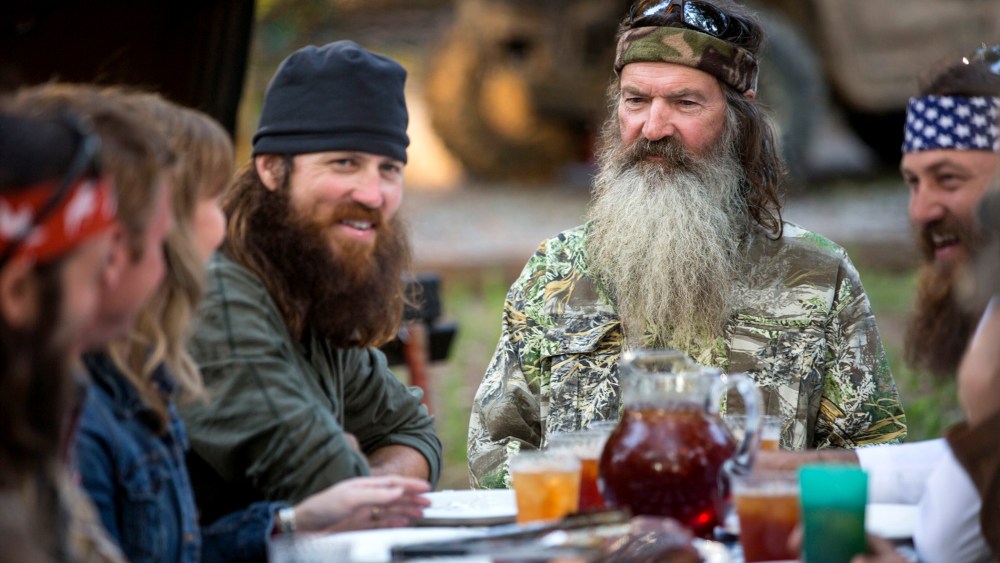 In an image released by A&E, Phil Robertson is flanked by his sons Jase Robertson, left, and Willie Robertson from the popular series "Duck Dynasty."