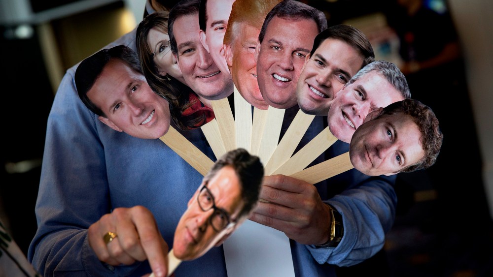 Adam Gabbatt of The Guardian newspaper holds images of possible Republican candidates during the Conservative Political Action Conference (CPAC) in National Harbor, Md. on Feb. 26, 2015.