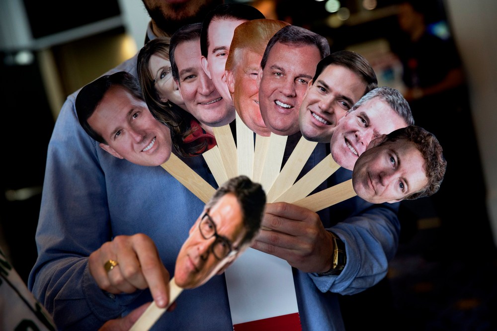 Adam Gabbatt of The Guardian newspaper holds images of possible Republican candidates during the Conservative Political Action Conference (CPAC) in National Harbor, Md. on Feb. 26, 2015.