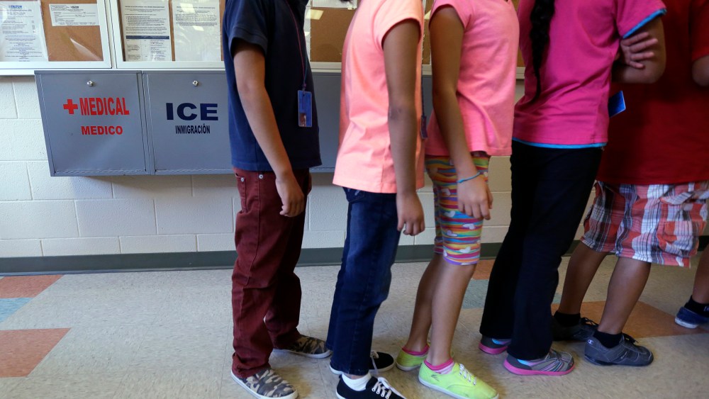 Detained immigrant children line up in the cafeteria at the Karnes County Residential Center, a temporary home for immigrant women and children detained at the border, Sept. 10, 2014, in Karnes City, Texas. (Photo by Eric Gay/AP)