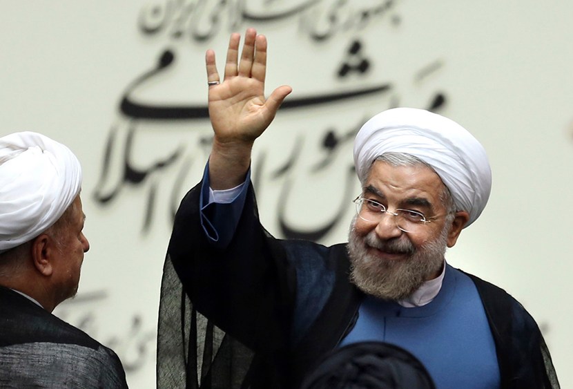 Iran's new President Hasan Rouhani, waves after swearing in at the parliament, in Tehran, Iran, Sunday, Aug. 4, 2013.  (Photo by Ebrahim Noroozi/AP)