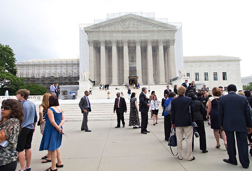 People wait outside the Supreme Court in anticipation of key decisions being announced, on Capitol Hill in Washington, Monday, June 17, 2013. (Photo by J. Scott Applewhite/AP)