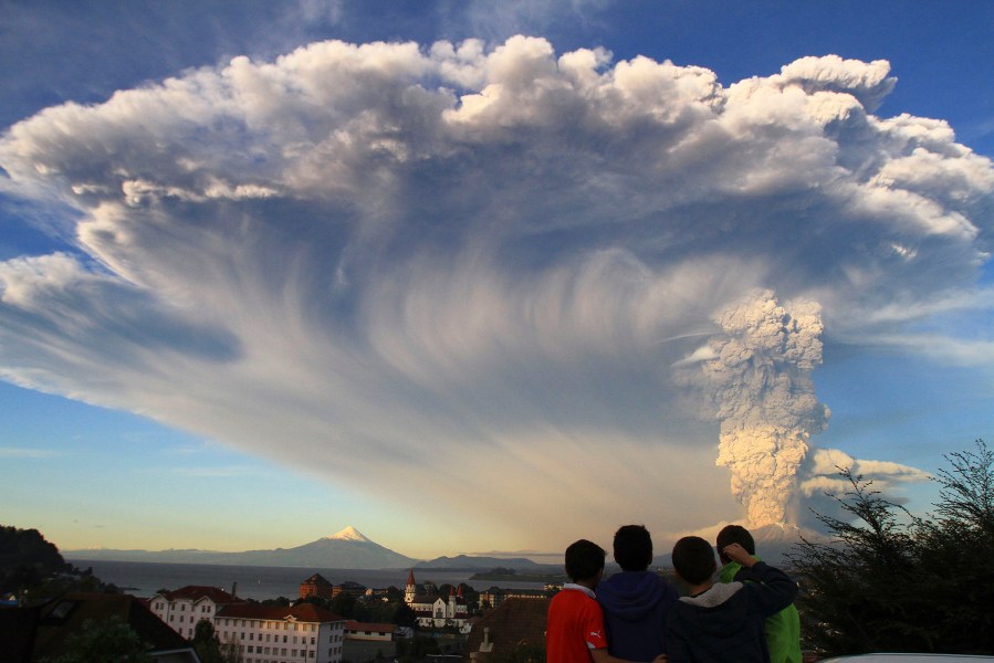 Children watch the Calbuco volcano erupt, from Puerto Varas, Chile, April 22, 2015. (Photo by Carlos F. Gutierrez/AP)