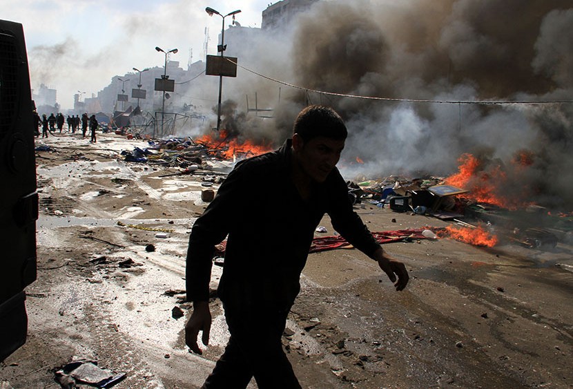 Egyptian security forces clear a sit-in by supporters of ousted Islamist President Mohammed Morsi in the eastern Nasr City district of Cairo, Egypt, Wednesday, Aug. 14, 2013. (Photo by Ahmed Gomaa/AP)