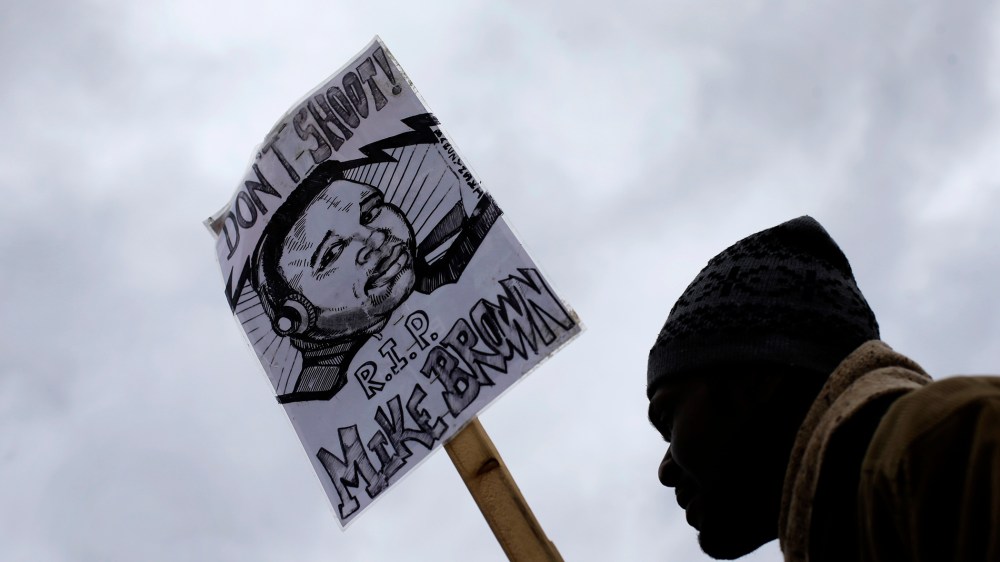 Rick Canamore, from Normandy, Mo. demonstrates against the August shooting of Michael Brown on Nov. 24, 2014, outside the police station in Ferguson, Mo. (Photo by Charlie Riedel/AP)
