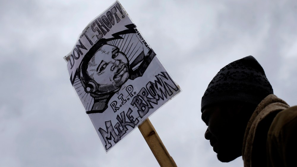 A man demonstrates against the August shooting of Michael Brown on Nov. 24, 2014, outside the police station in Ferguson, Mo. (Photo by Charlie Riedel/AP)