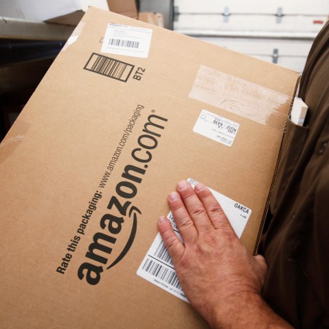 In this Oct. 18, 2010 file photo, United Parcel Service (UPS) driver delivers an Amazon box. (Photo by Paul Sakuma/AP)