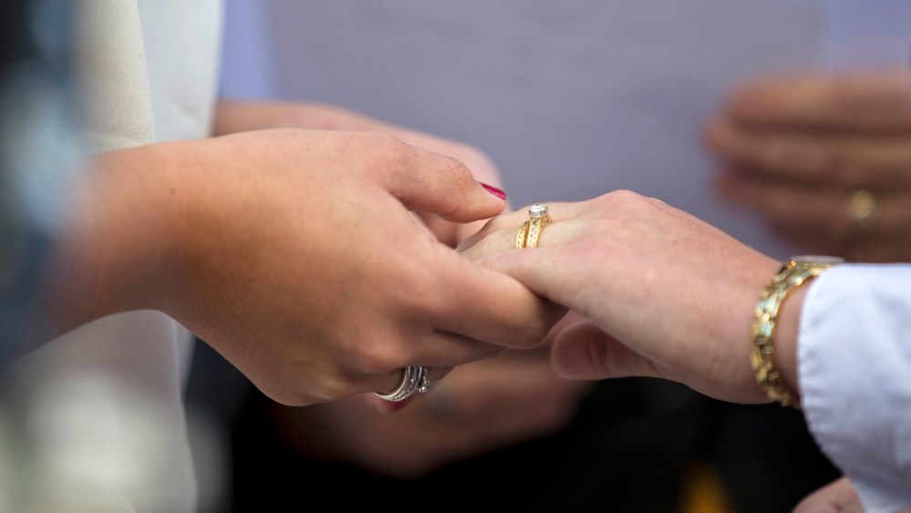 Two women hold hands after exchanging wedding rings during a ceremony. (Photo by Manuel Balce Ceneta/AP)