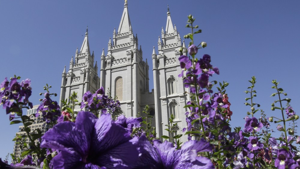 In this Sept. 3, 2014, file photo, shows flowers blooming in front of the Salt Lake Temple. in Temple Square, in Salt Lake City. (Photo by Rick Bowmer/AP)