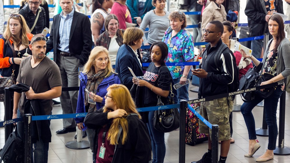 Travelers in line at Los Angeles International airport Monday, April 22, 2013. (AP Photo/Damian Dovarganes)
