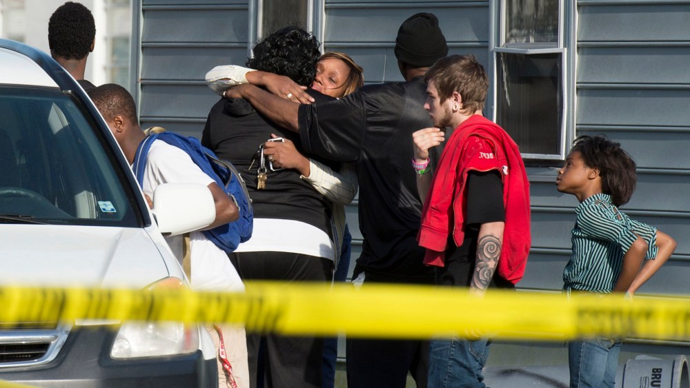 Onlookers gather outside of a house, where police say seven children and one adult were found dead on April 6, 2015, in Princess Anne, Md. (Photo by Joe Lamberti/The Daily Times/AP)