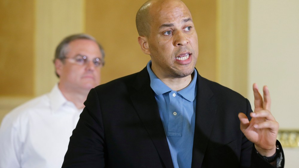 U.S. Sen. Cory Booker, D-N.J., right, speaks during a news conference at the Arkansas state Capitol in Little Rock, Ark., as U.S. Sen. Mark Pryor listens on May 31, 2014.