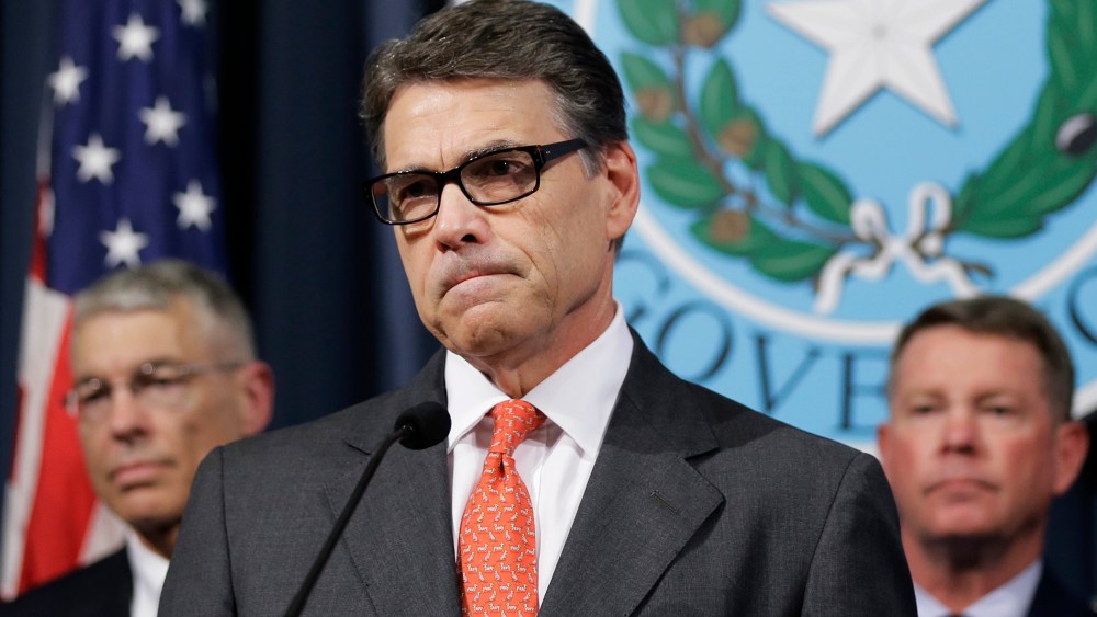 Gov. Rick Perry listens to a reporter's question during a news conference in the Governor's press room, July 21, 2014, in Austin, Texas.
