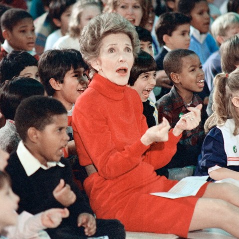 First Lady Nancy Reagan watches an anti-drug musical entitled Just Say No performed by teenage students from the Chantilly, Va., High School at the Cameron Elementary School, Feb. 26, 1987. (Photo by Scott Stewart/AP)
