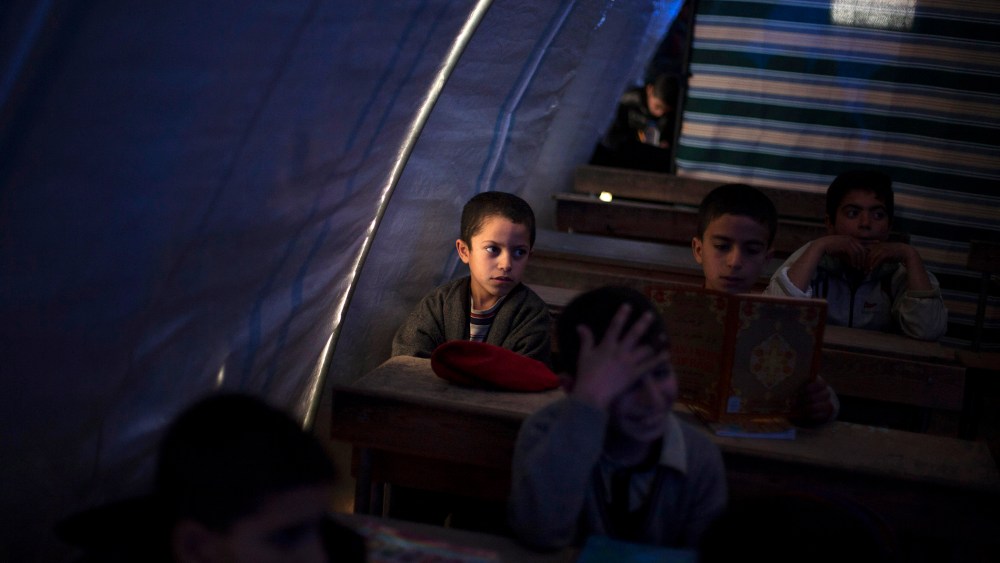 Displaced Syrian children attend school in a makeshift classroom in the Azaz camp for displaced people, north of Aleppo province, Syria, on Feb. 20, 2013.