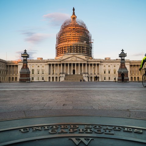 A cyclist rides across the front plaza of the US Capitol early in the morning on Nov. 4, 2014 in Washington, D.C. (Photo by J. David Ake/AP)