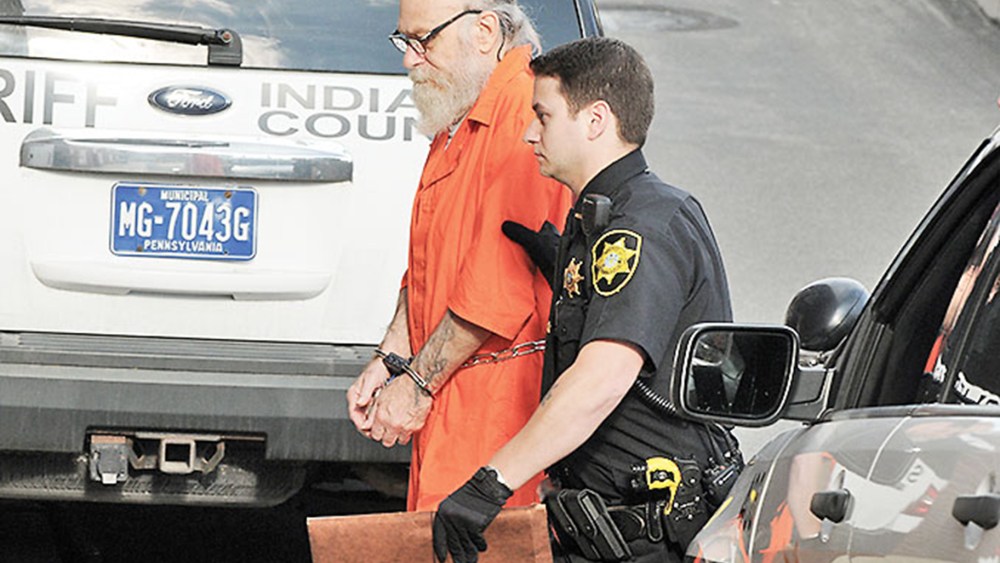 Lewis Fogle is escorted to the back door of the Indiana County Courthouse by Deputy Dave Angelo in Indiana, Pa., Aug. 13, 2015. (Photo by Tom Peel/The Indiana Gazette/AP)