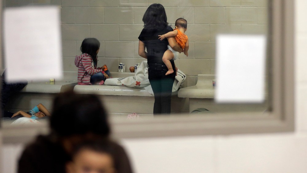 Detainees wait in a holding cell at a U.S. Customs and Border Protection processing facility, June 18, 2014, in Brownsville, Texas.