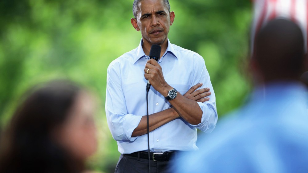 President Barack Obama listens to a speaker at an invite-only town hall meeting on Thursday, June 26, 2014, at Minnehaha Park in Minneapolis, Minn.